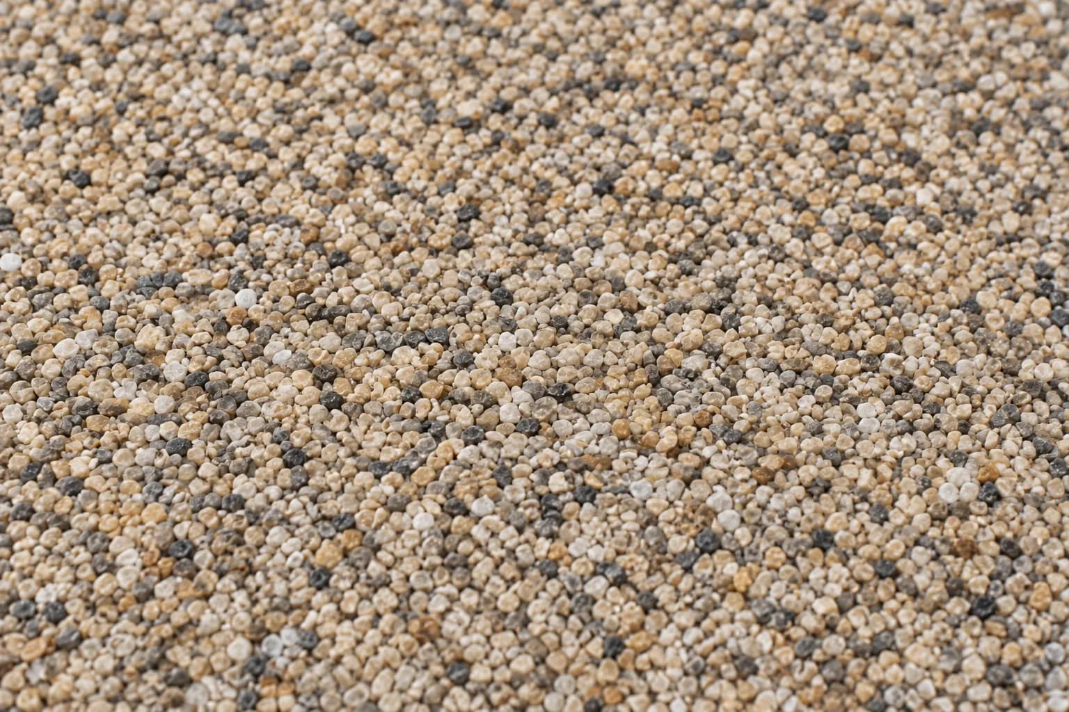 Illustrated close-up of a rough, scattered aggregate surface